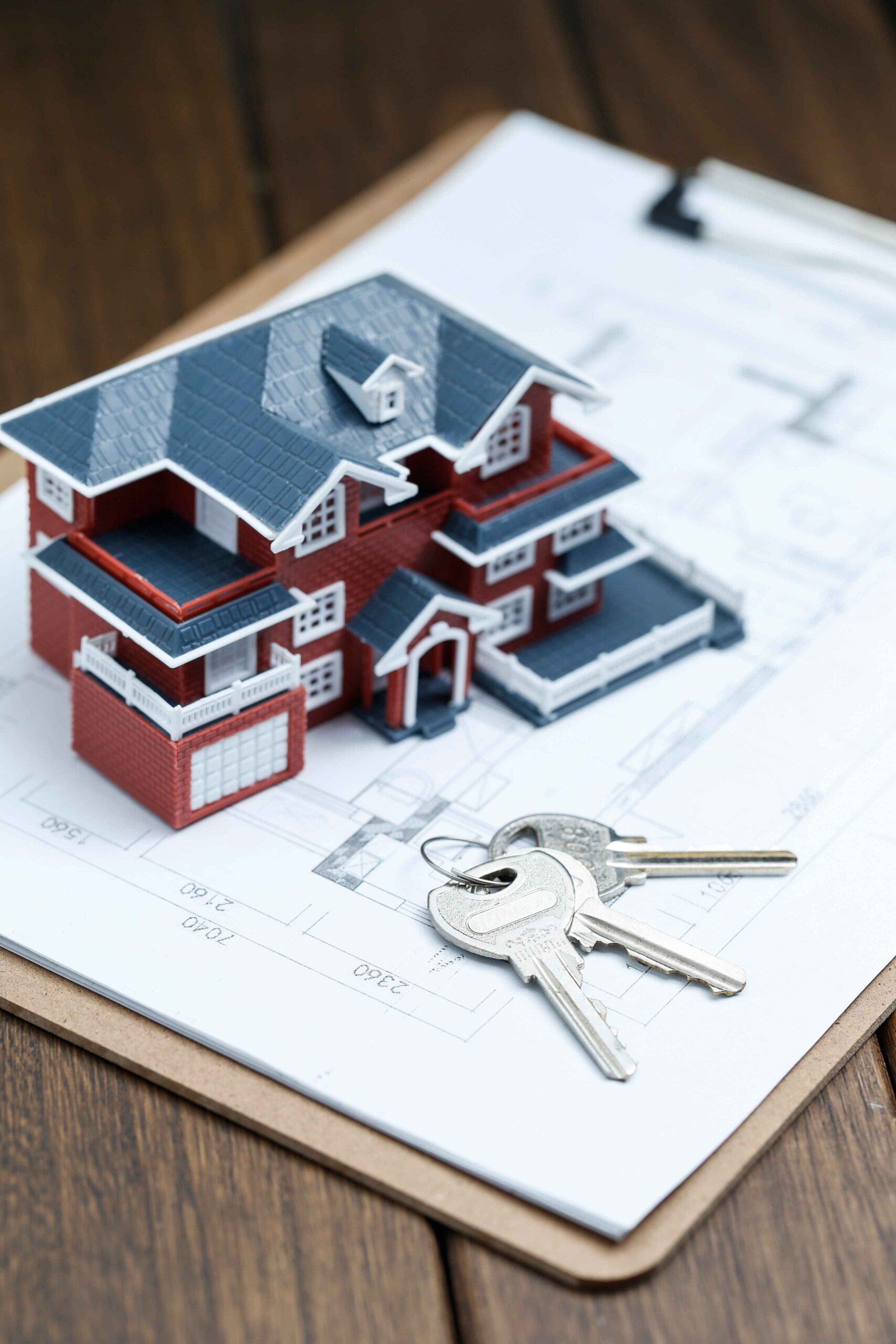 House model with keys and mortgage documents