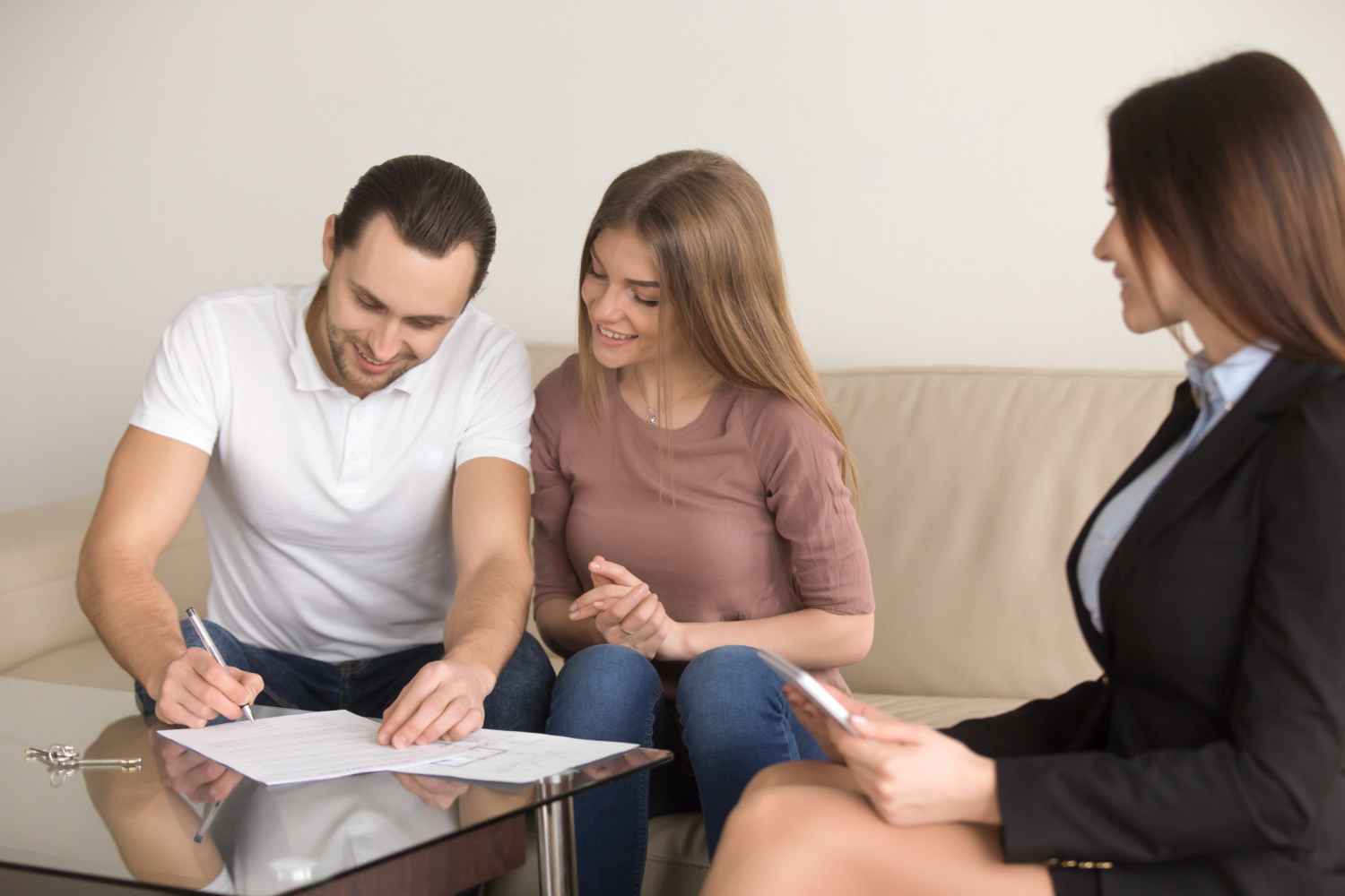 Couple signing documents for a property purchase in Spain